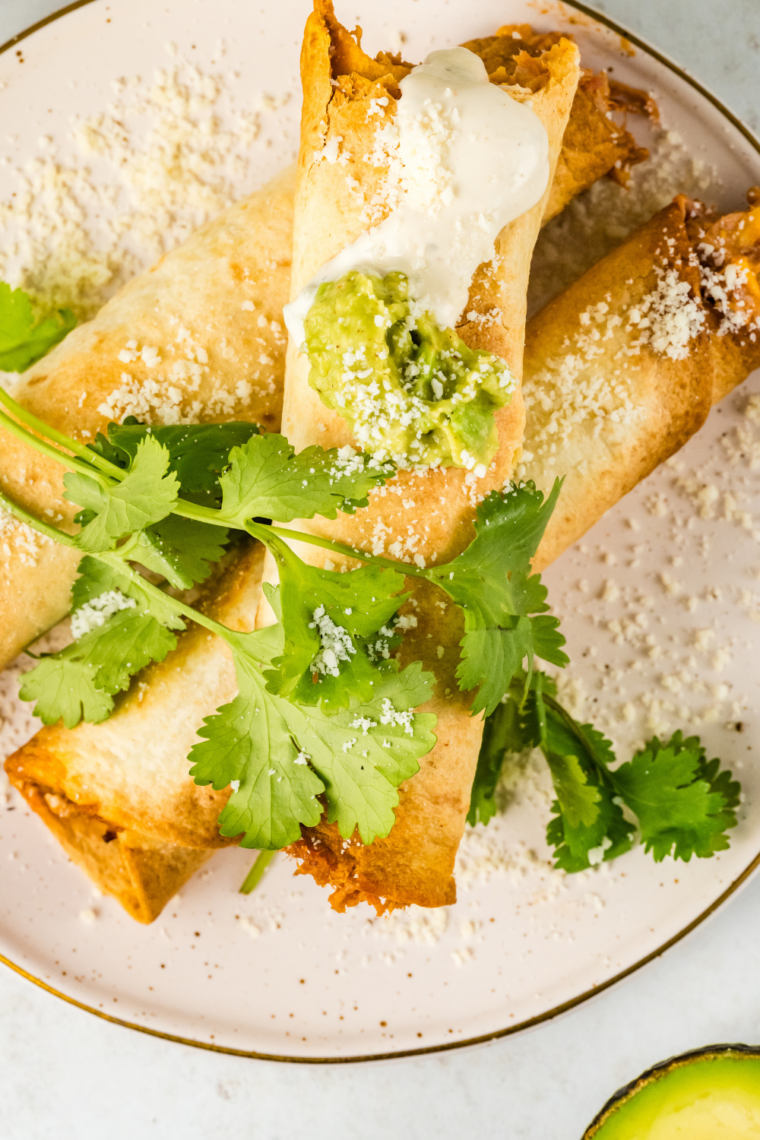 Air fryer hot dog taquitos made with tortillas wrapped around hot dogs, cooked until golden, crispy, and cheesy inside.