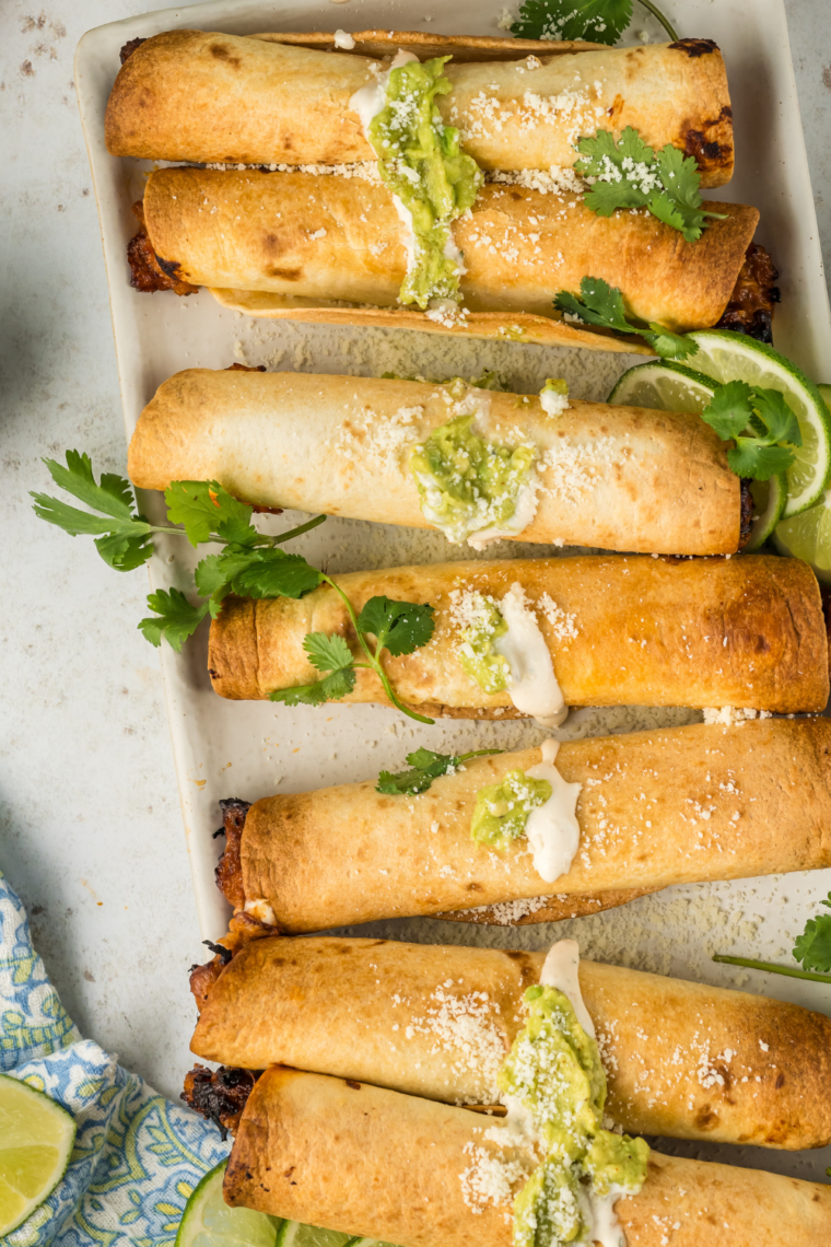 Air fryer hot dog taquitos made with tortillas wrapped around hot dogs, cooked until golden brown, crispy, and cheesy inside.
