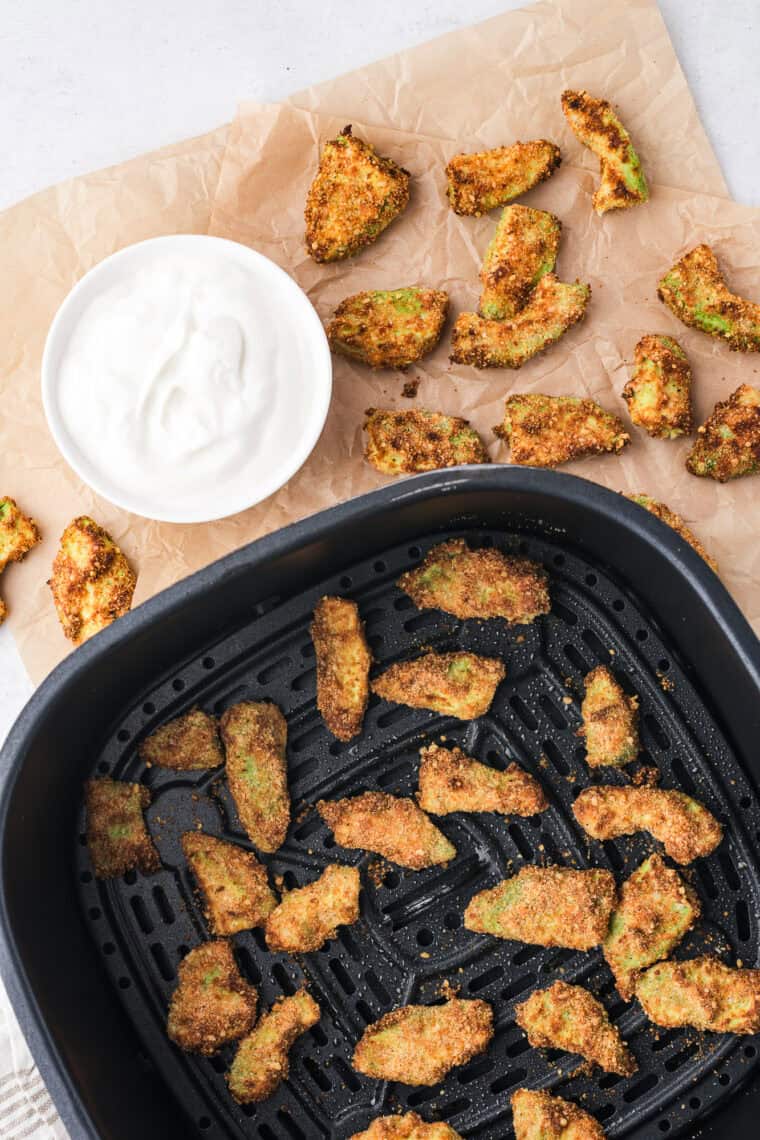 golden, crispy air fryer avocado chips served on plate with dipping sauce