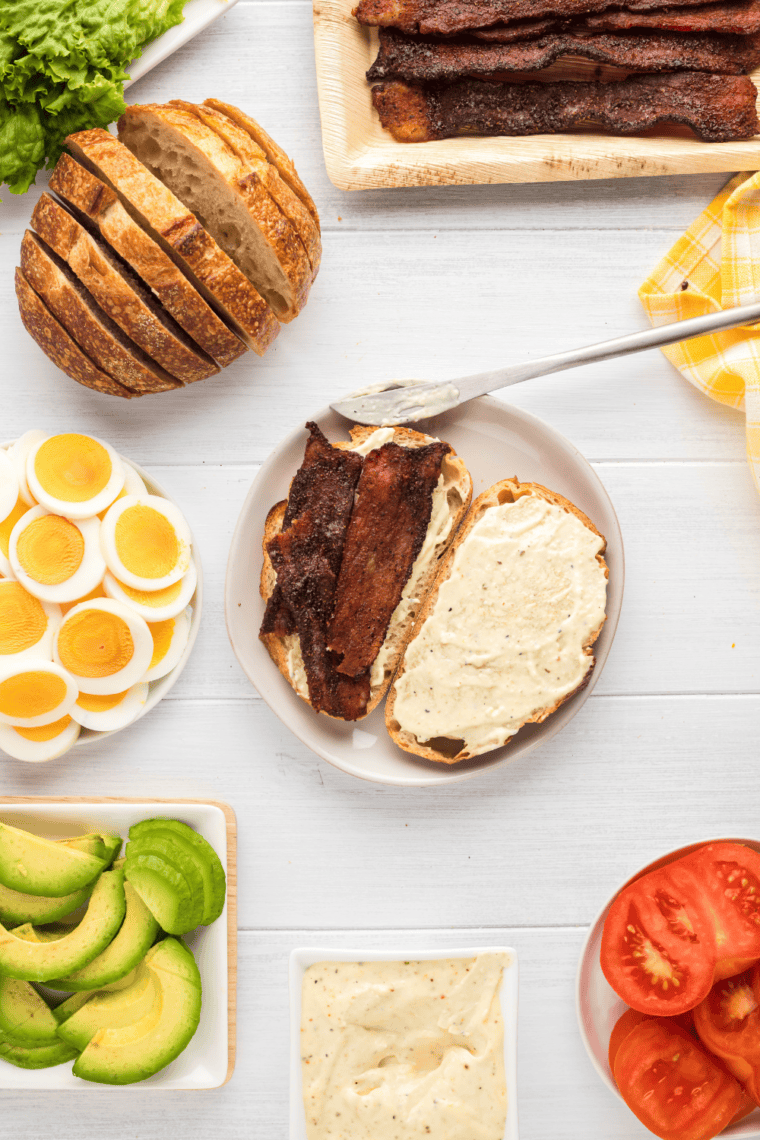 Spreading mayonnaise on toasted bread for creaminess