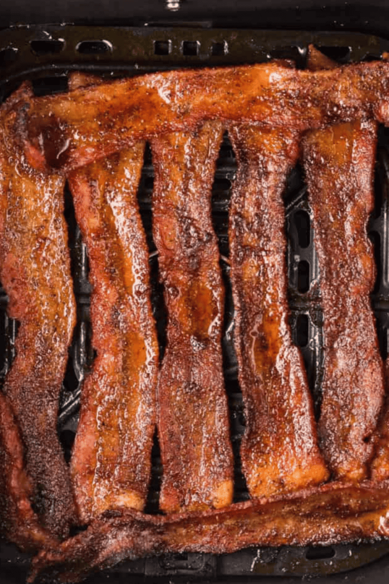 Cooking crispy bacon in skillet until golden.