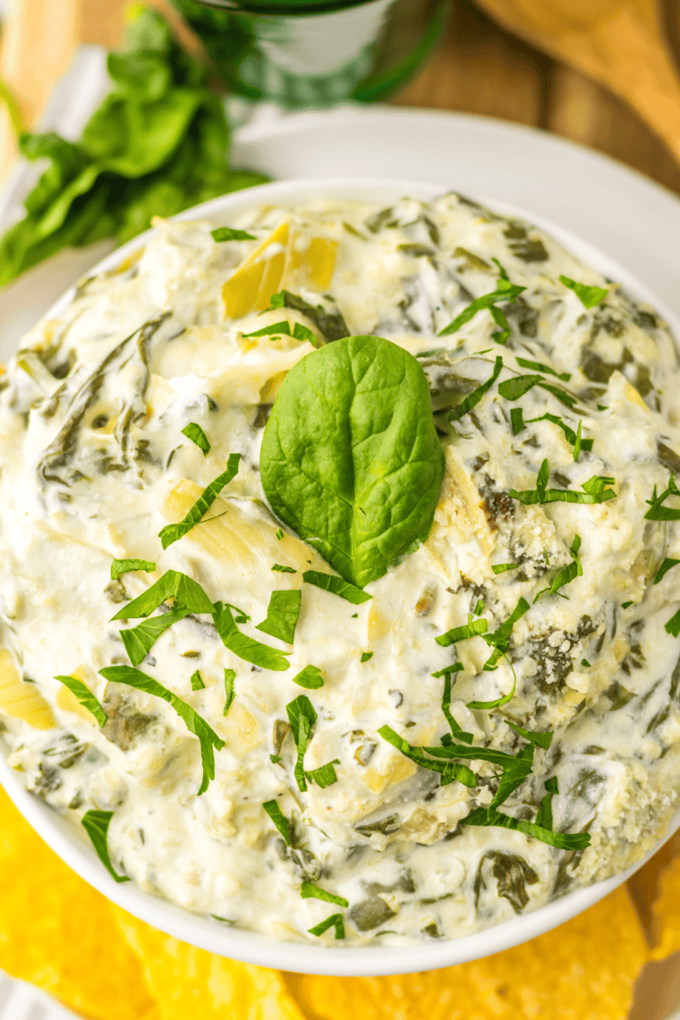 Creamy copycat Cheesecake Factory Spinach Dip served warm with tortilla chips in a bowl