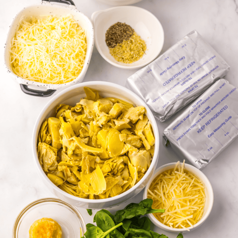 Ingredients needed for Cheesecake Factory Spinach Dip Recipe on kitchen table.