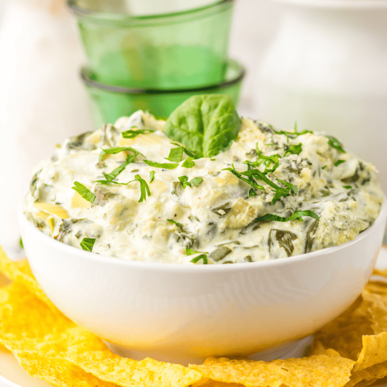 Creamy Cheesecake Factory spinach dip with melted cheese and spinach served warm with chips or bread for dipping