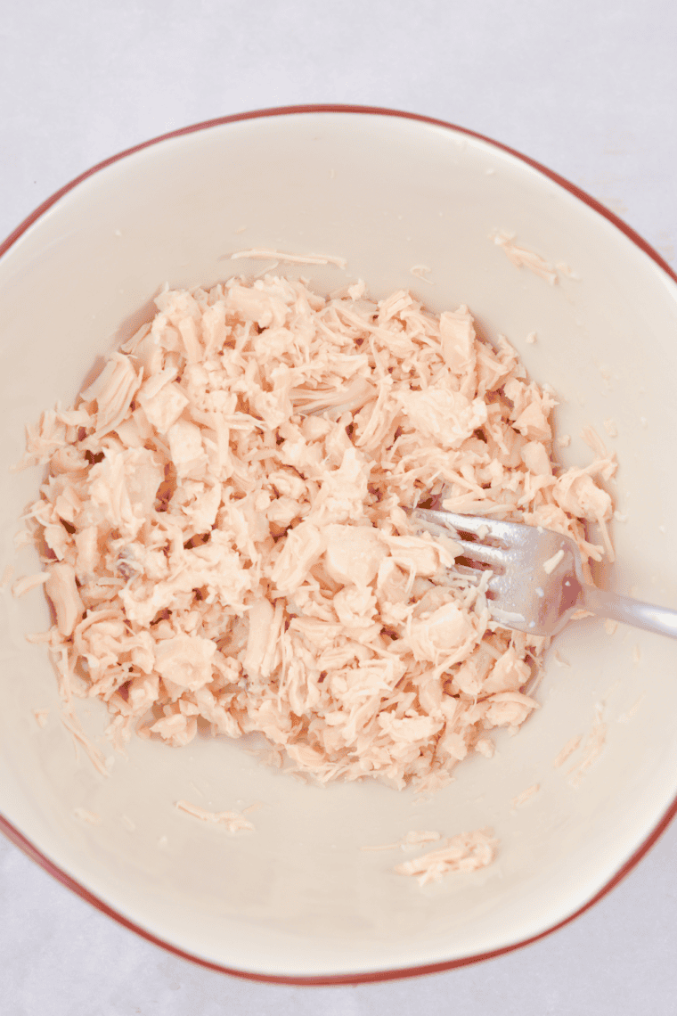 Chicken tenderloins gently poached in simmering water or broth in a pot, cooked until 165&deg;F for tender, juicy texture.