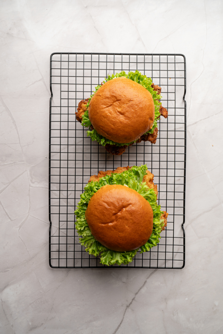 Golden fried chicken breast sandwich with lettuce, pickles, and mayo on a soft toasted bun, copycat fast food style.