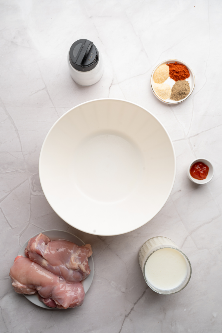 Ingredients needed for Copycat Hardee's Hand-Breaded Chicken Sandwich on kitchen table.