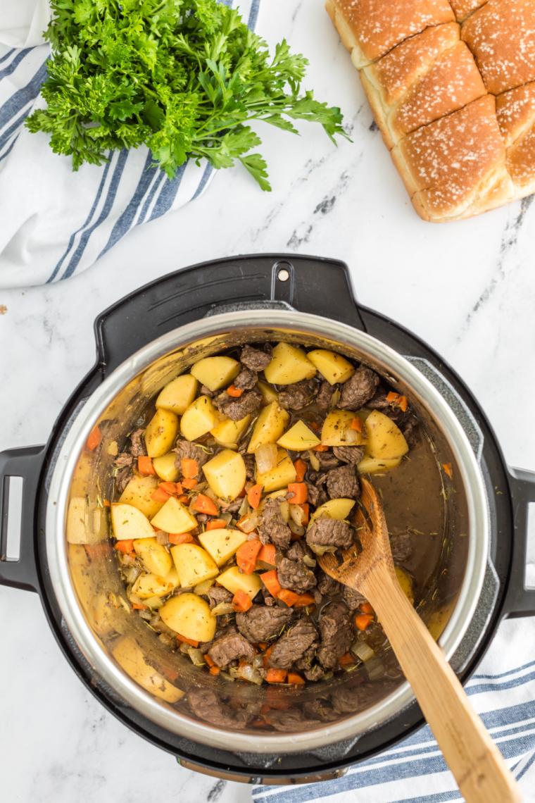 Cooking diced onions and garlic in pot until soft and fragrant