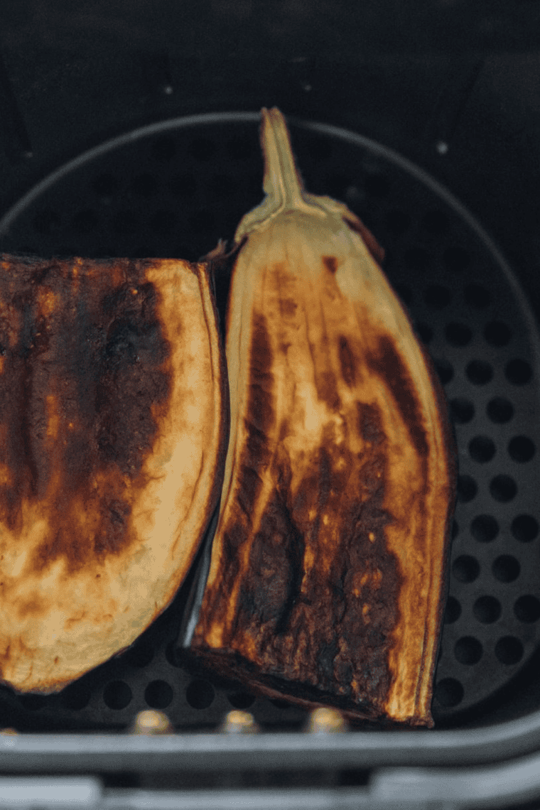 Eggplant roasting in oven until soft, tender, and fully collapsed