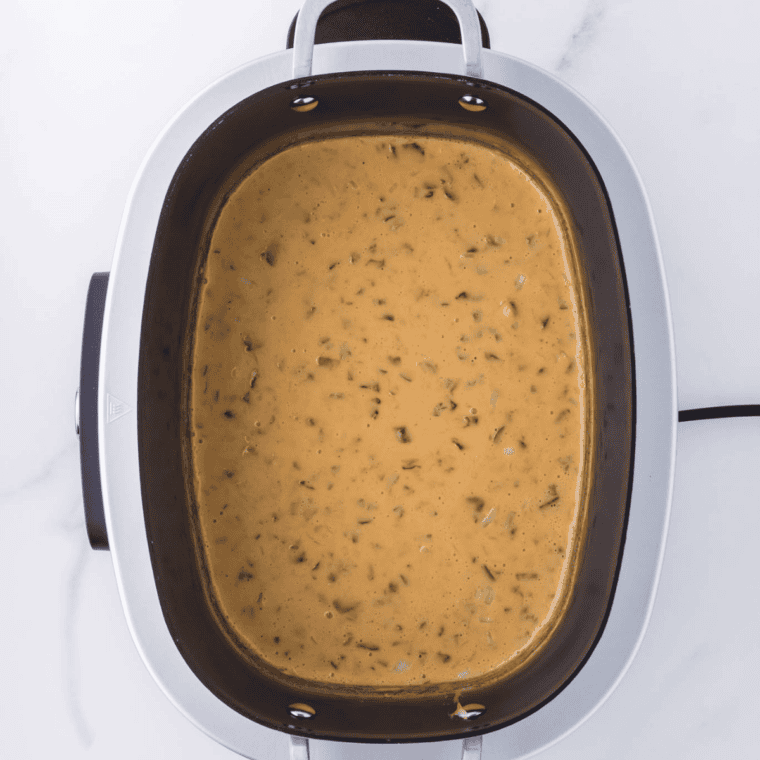 rich and creamy crockpot cream cheese dip served warm with chips for an easy party appetizer