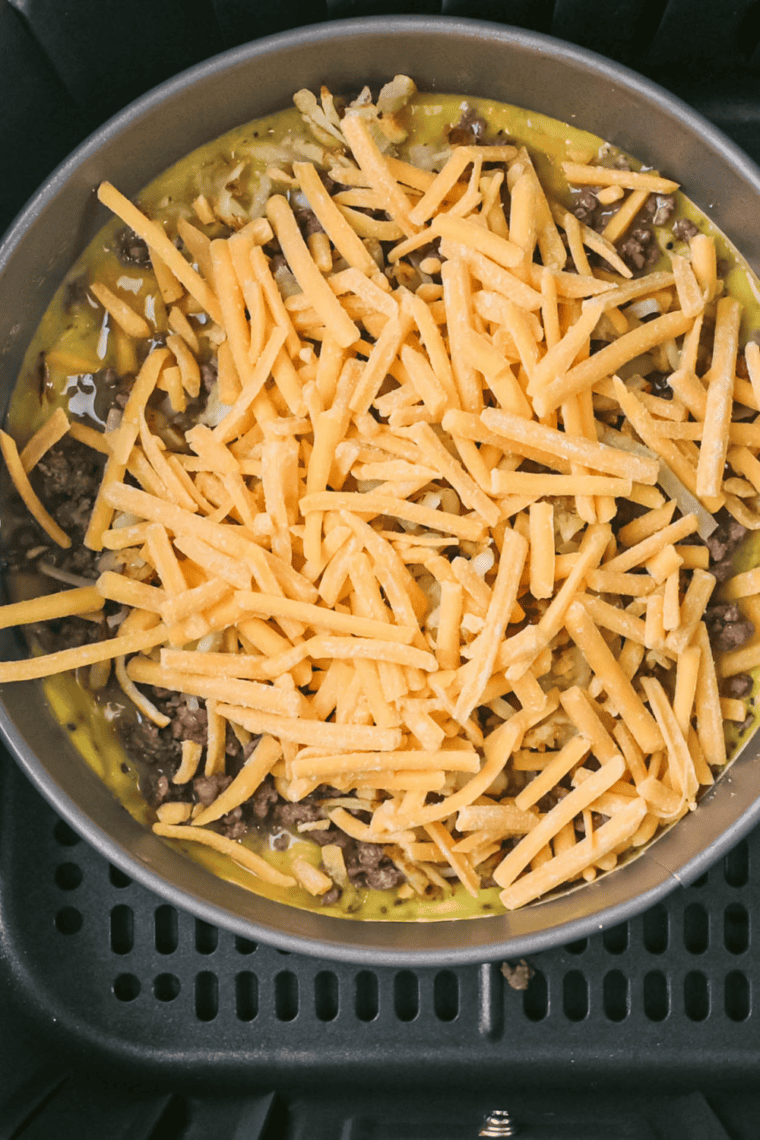 Egg mixture poured into greased air fryer pan or silicone mold ready to cook