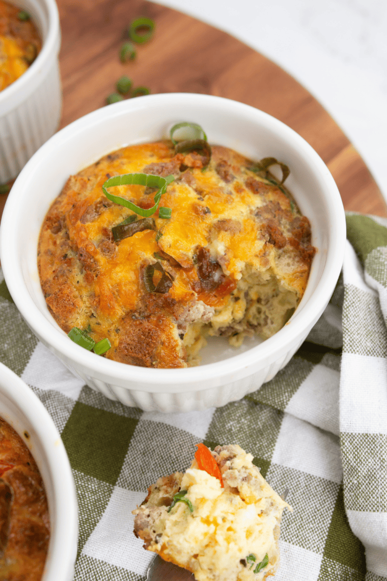 Golden baked breakfast strata casserole made with layers of bread, eggs, cheese, and savory ingredients in a baking dish.