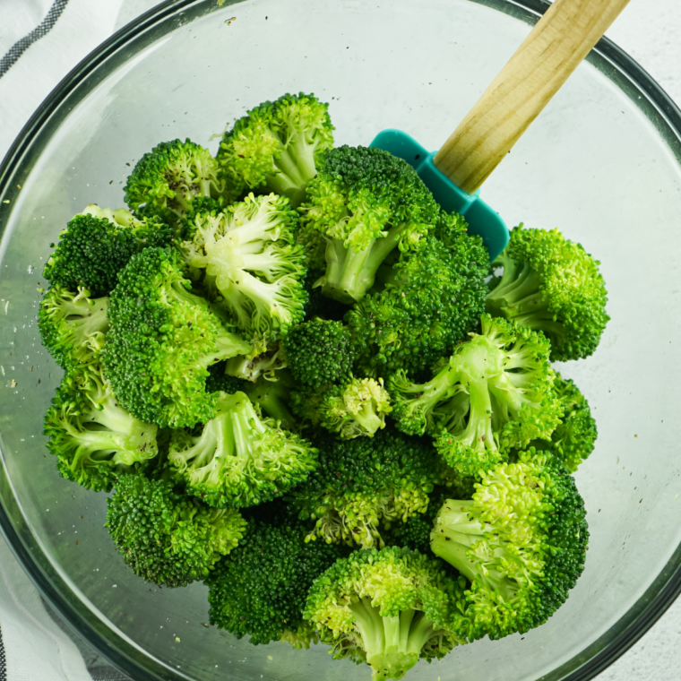 Roasting broccoli florets with Parmesan and seasonings at high heat until golden and crispy