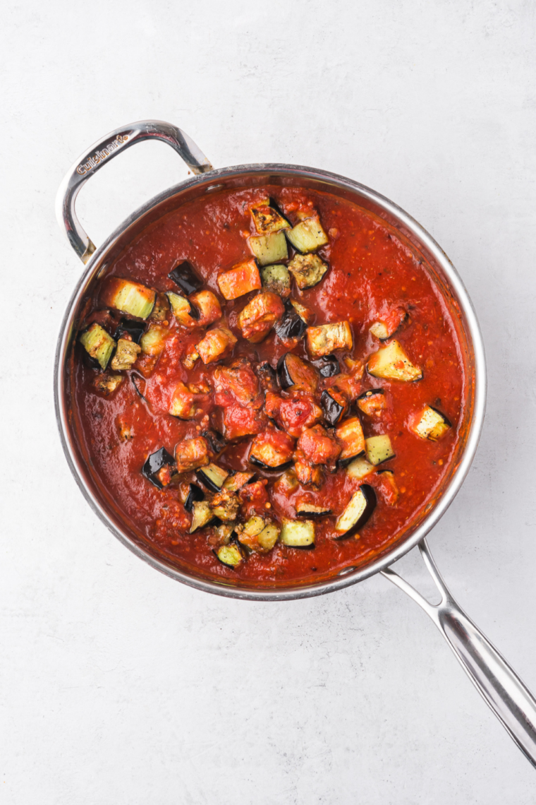 Homemade Fazoli&rsquo;s style spaghetti sauce simmering in a pot with tomatoes, herbs, and savory Italian seasoning served over pasta