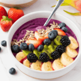 Chia pudding bowl inspired by First Watch topped with fresh berries, granola, and nuts in a glass jar for a healthy superfood breakfast.