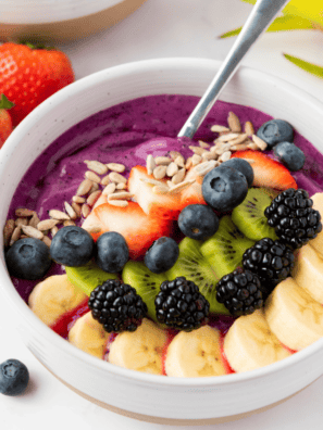 Chia pudding bowl inspired by First Watch topped with fresh berries, granola, and nuts in a glass jar for a healthy superfood breakfast.