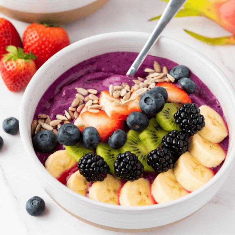 Finished chia pudding bowl topped with berries, granola, and nuts served chilled