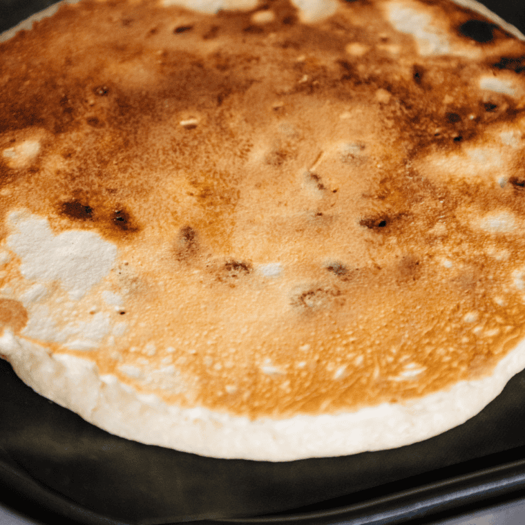 Flipping pancakes when bubbles form and edges set