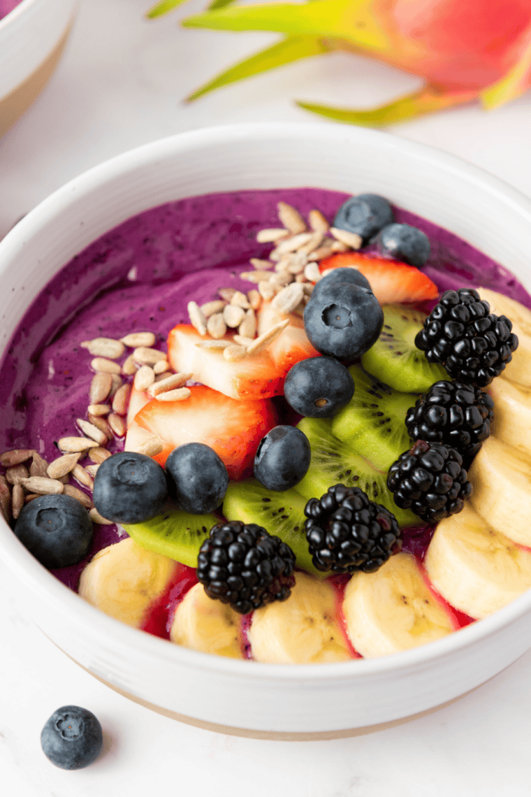 Chia pudding bowl inspired by First Watch topped with berries, granola, nuts, and coconut flakes in a glass jar for a healthy superfood breakfast.