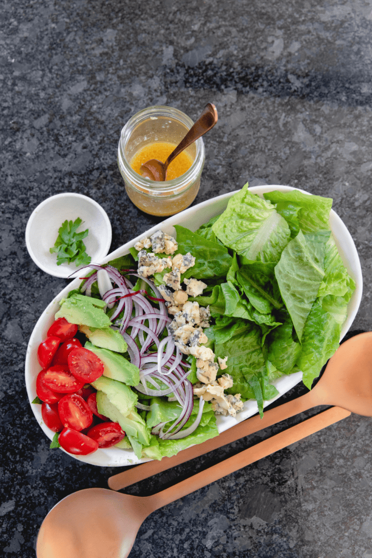 Sliced boiled eggs, avocado, tomatoes, and red onion prepared