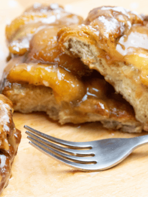 First Watch Floridian French Toast topped with fresh fruit, powdered sugar, and syrup on a white plate