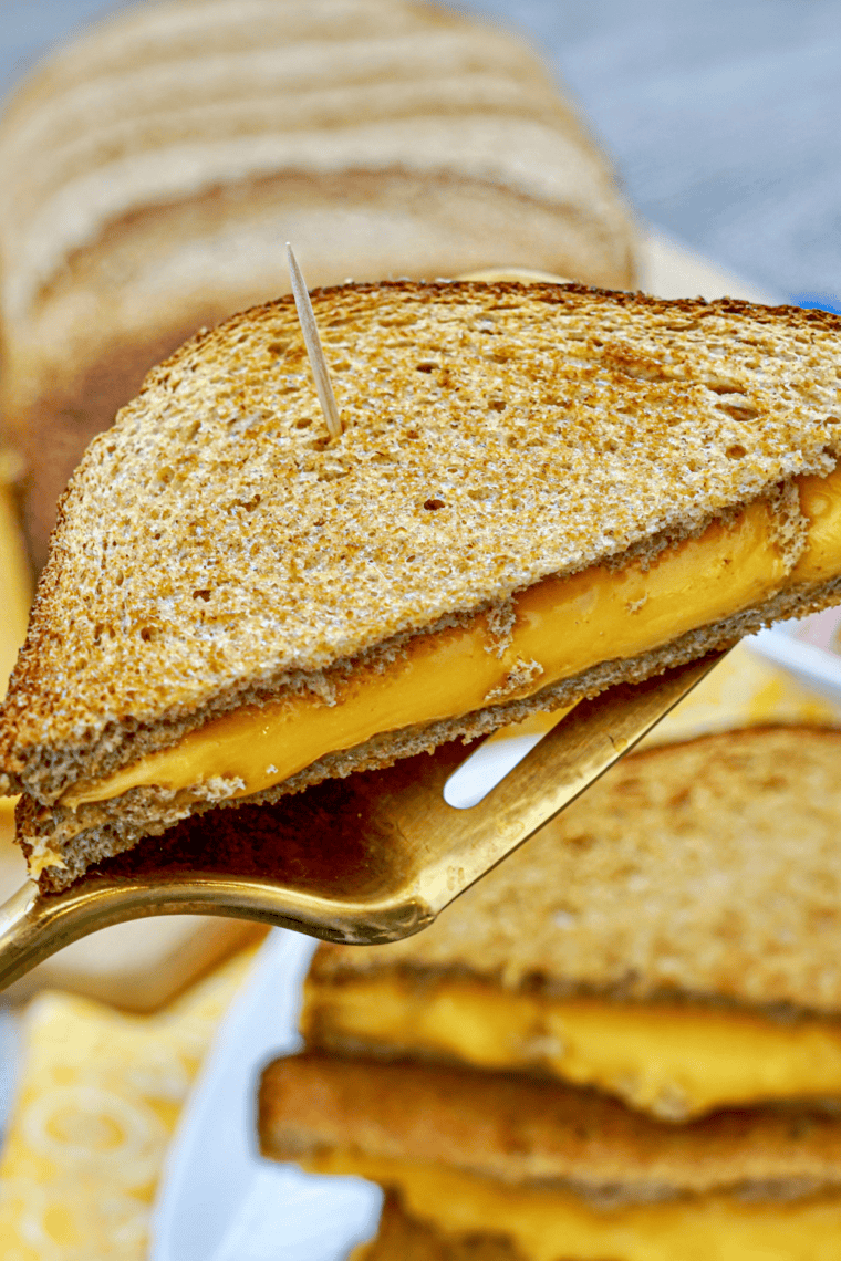 Golden grilled cheese sandwich made with sourdough bread, crispy buttered crust, and melted cheddar and American cheese inside, inspired by First Watch.