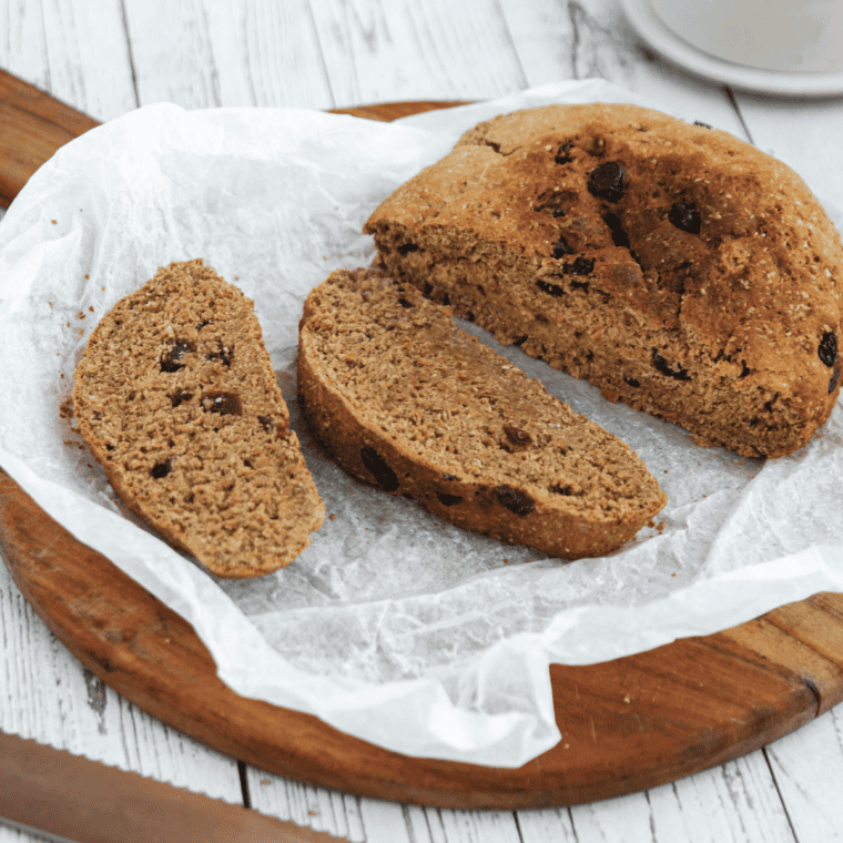 Freshly baked First Watch style multigrain bread loaf with seeds and oats on top, cooling on a wire rack
