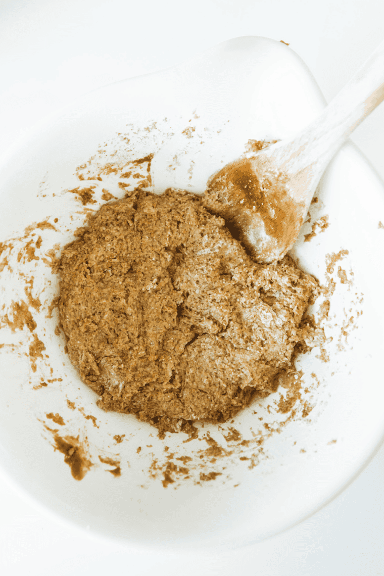 Mixing the foamy yeast mixture and olive oil into dry ingredients to form dough.