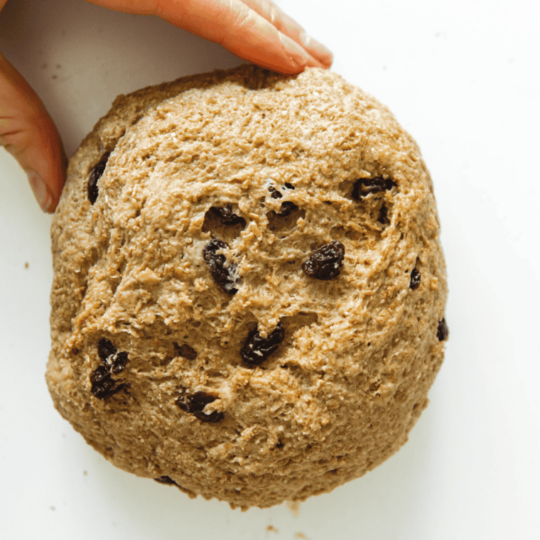 Dough in greased bowl covered with towel rising until doubled in size.