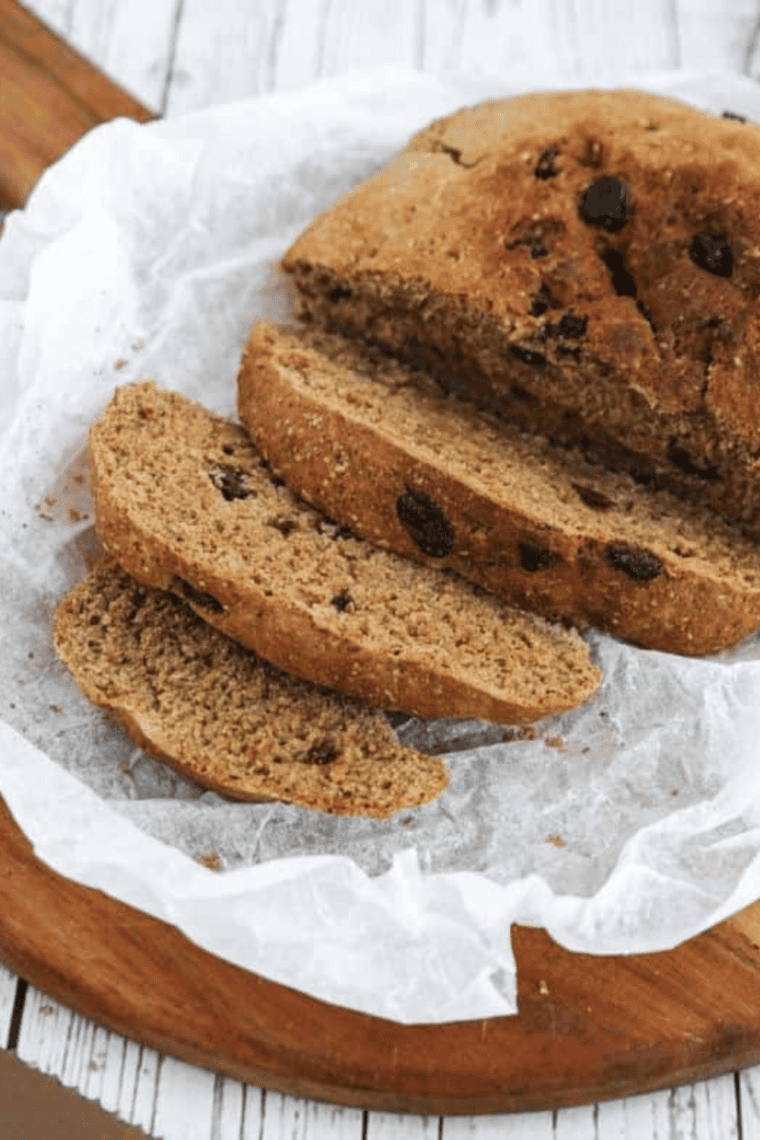 Freshly baked First Watch Multigrain Bread loaf with seeds and grains on a cutting board.