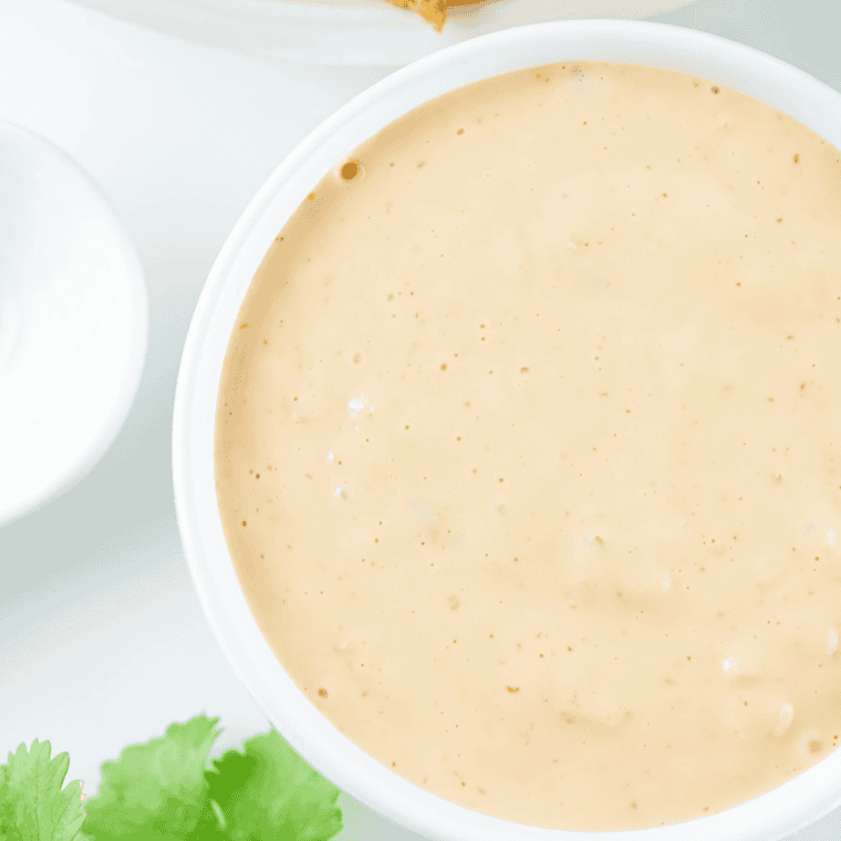 Creamy Gordon Ramsay peppercorn sauce in a skillet with cracked black pepper, butter, shallots, and cream creating a rich steakhouse-style finish.