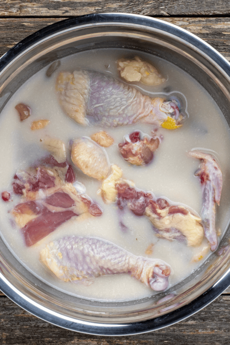 Chicken soaking in buttermilk marinade to tenderize and add moisture