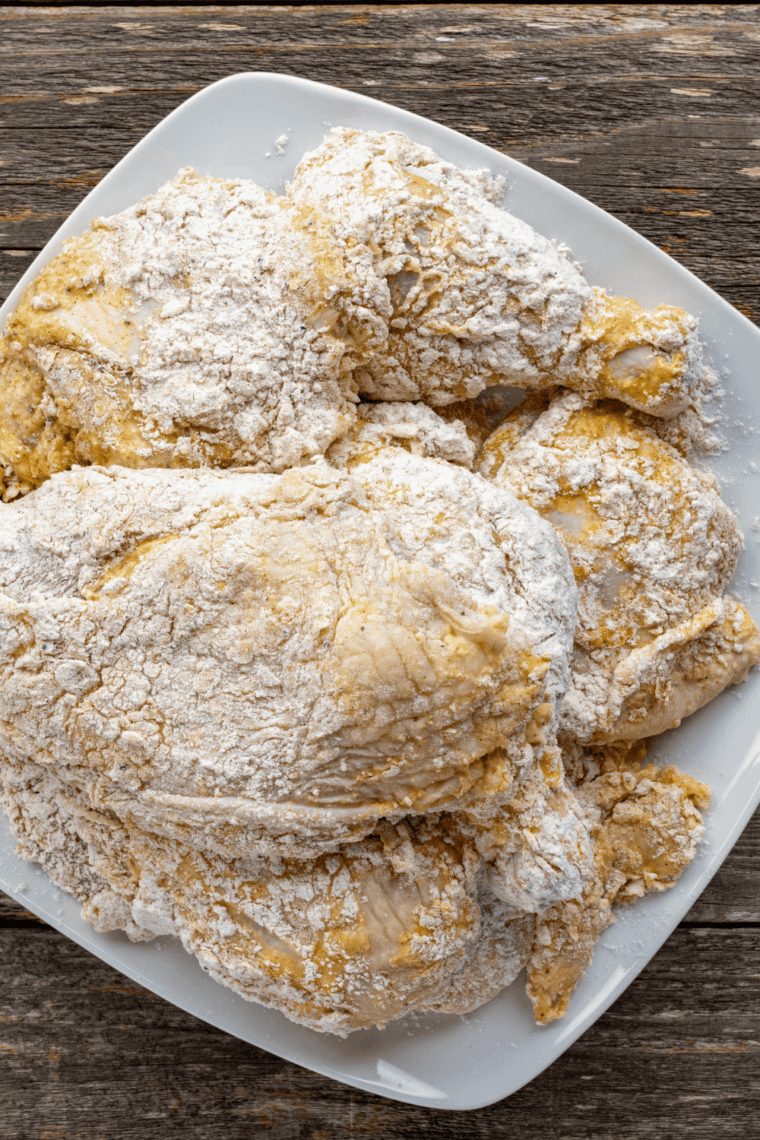 Flour mixed with spices creating seasoned coating for fried chicken