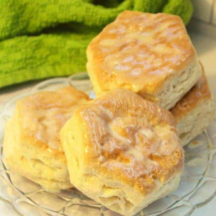 Buttermilk brushed tops bake into tall golden flaky biscuits