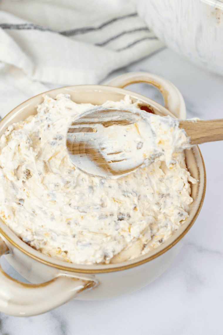 Creamy veggie dip with fresh herbs served alongside carrots, celery, cucumbers, and bell peppers for a simple and delicious appetizer.