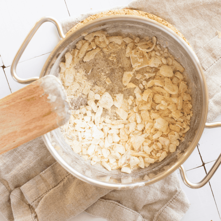 Butter melting in pot with onions cooking until soft and garlic added for aroma