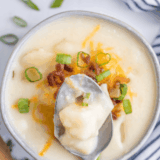 Creamy McAlister&rsquo;s-style potato soup in a bowl topped with cheese, bacon, and green onions, rich and hearty loaded potato soup copycat recipe.