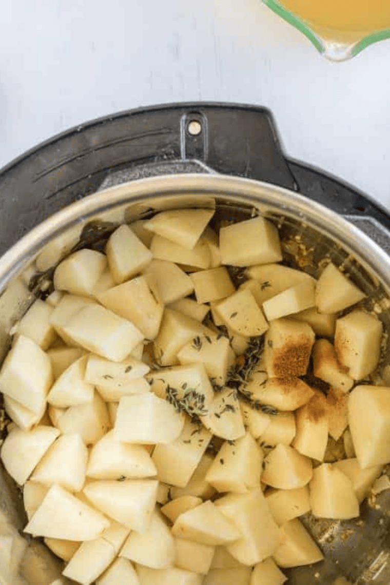 Butter onion and garlic saut&eacute;ing in Instant Pot creating savory soup base
