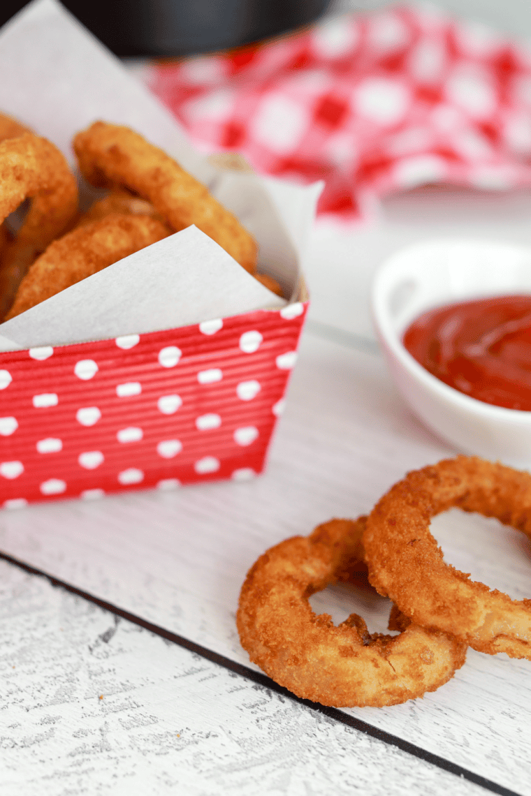 Homemade Red Robin spicy ketchup in a bowl served with crispy fries, rich red dipping sauce with sweet and spicy flavor profile