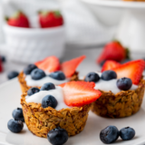 Red white and blue granola berry cups layered with fresh berries and crunchy granola in clear cups