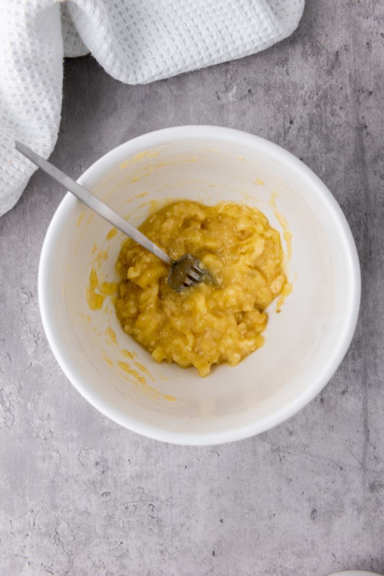 Mashed ripe banana in bowl until mostly smooth