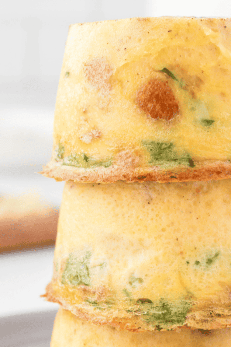 Fluffy baked Scooter&rsquo;s style egg bites made with eggs, cheese, and mix-ins served warm on a plate for a quick protein breakfast or meal prep snack.