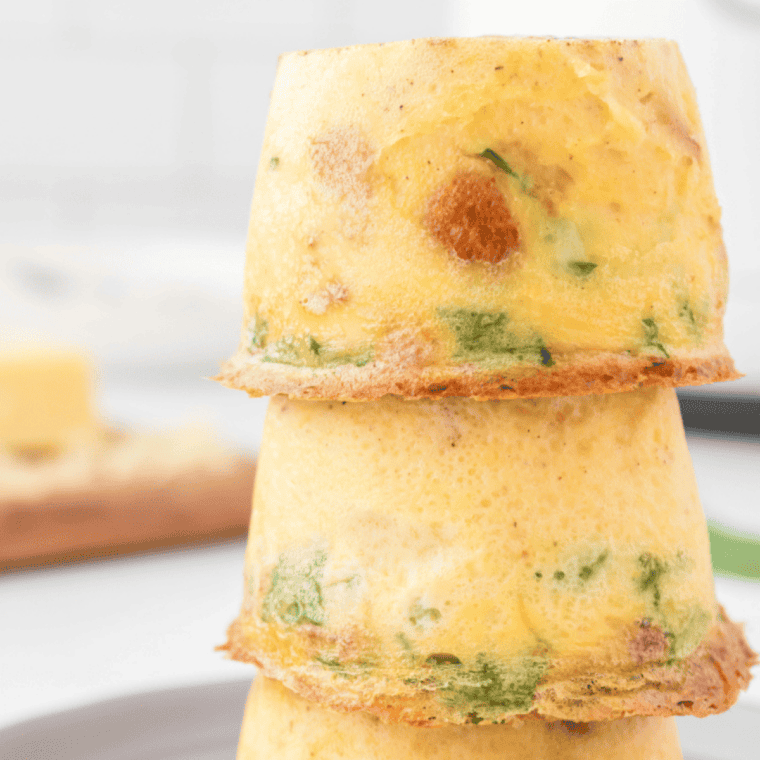 Fluffy baked Scooter&rsquo;s style egg bites made with eggs, cheese, and mix-ins served warm on a plate for a quick protein breakfast or meal prep snack.
