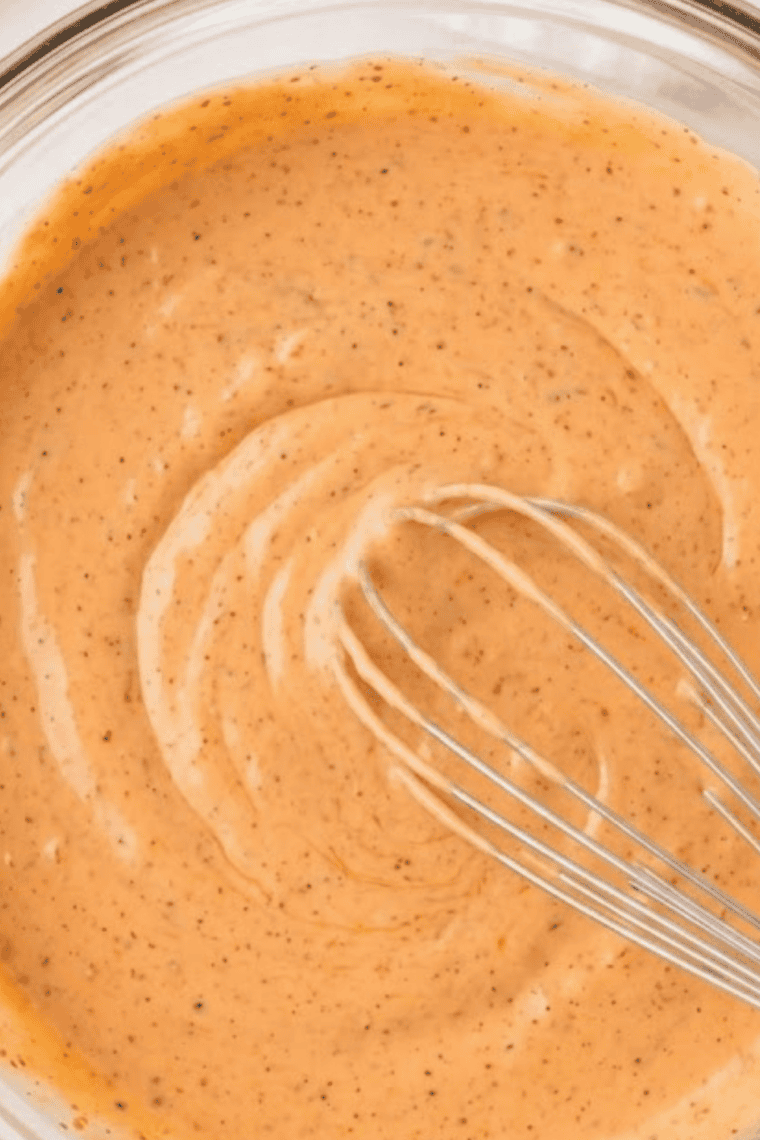 Creamy mayonnaise and ranch dressing mixed together in a bowl until smooth, forming the base for Sonic Groovy Sauce.