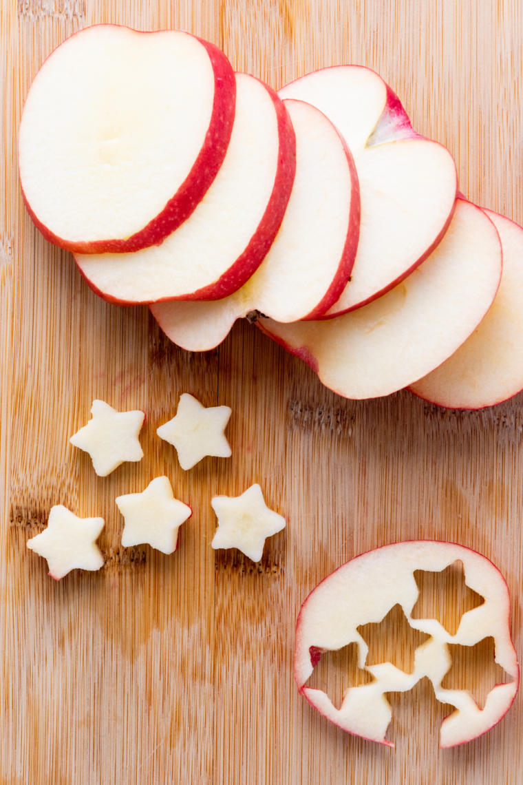 Star shaped apples mixed with strawberries and blueberries in a bowl