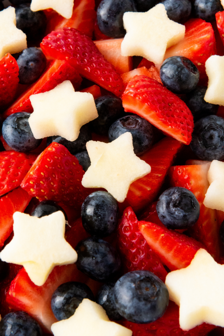 Close up of patriotic fruit salad with star shaped apple slices and fresh summer berries