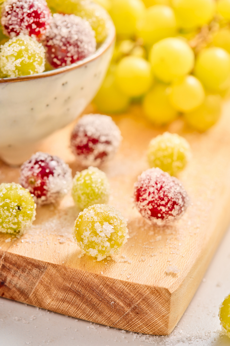 Bunch of sugar coated grapes in a glass bowl ready to serve as a sweet snack