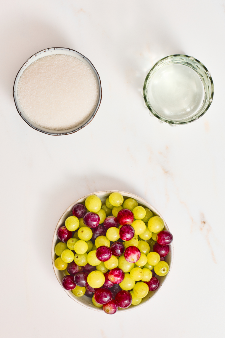 Ingredients needed for Sugar Coated Grapes on kitchen table.