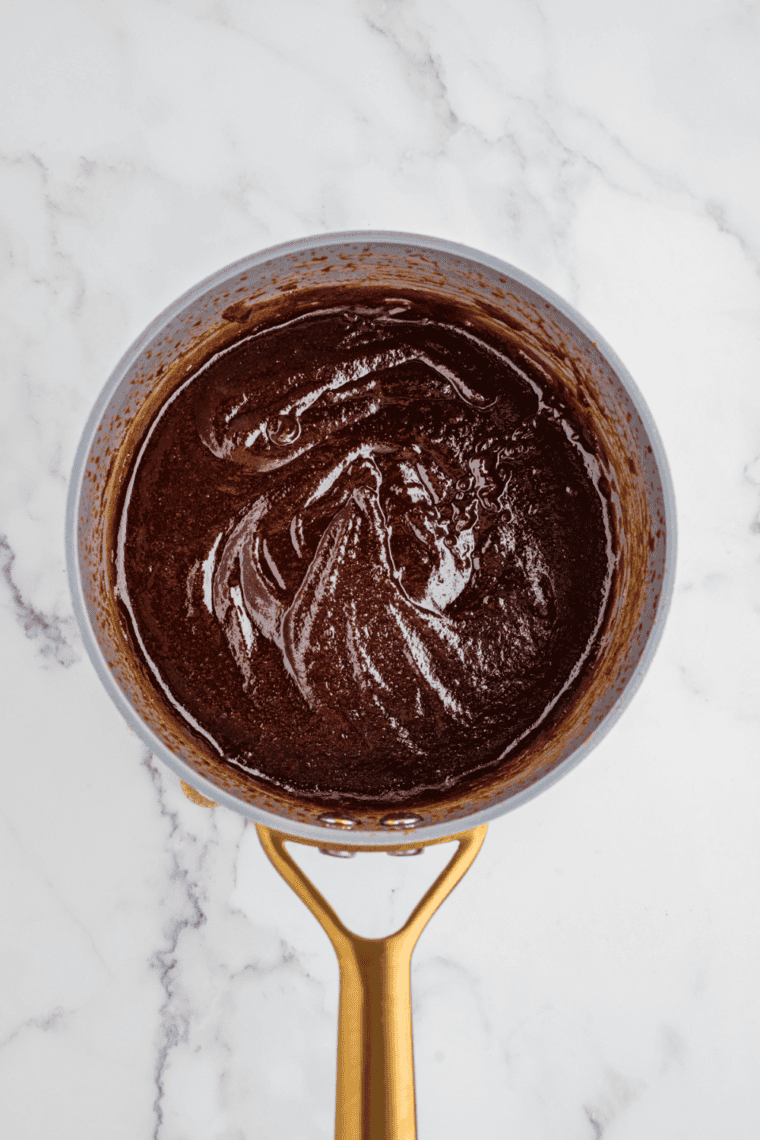 Homemade Wood Ranch BBQ sauce in a bowl with rich smoky red color, perfect for ribs, chicken, and grilled meats