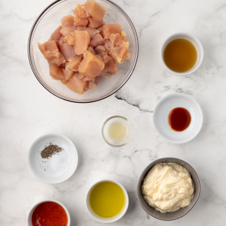 Ingredients needed for Air Fryer Bang Bang Chicken Skewers on kitchen table.